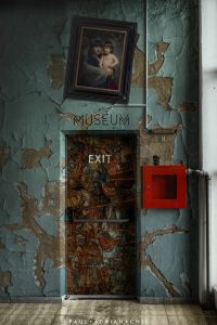 Artist sudio exit door with old walls and crooked artportrait on the wall